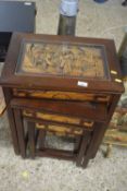 A nest of five Oriental hardwood occasional tables with carved decoration