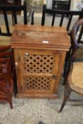 An Indian hardwood bedside cabinet with meshed door