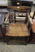 An early 19th Century elm seated carver chair
