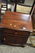A dark stained pine bedside cabinet
