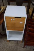 A modern white finish bedside cabinet
