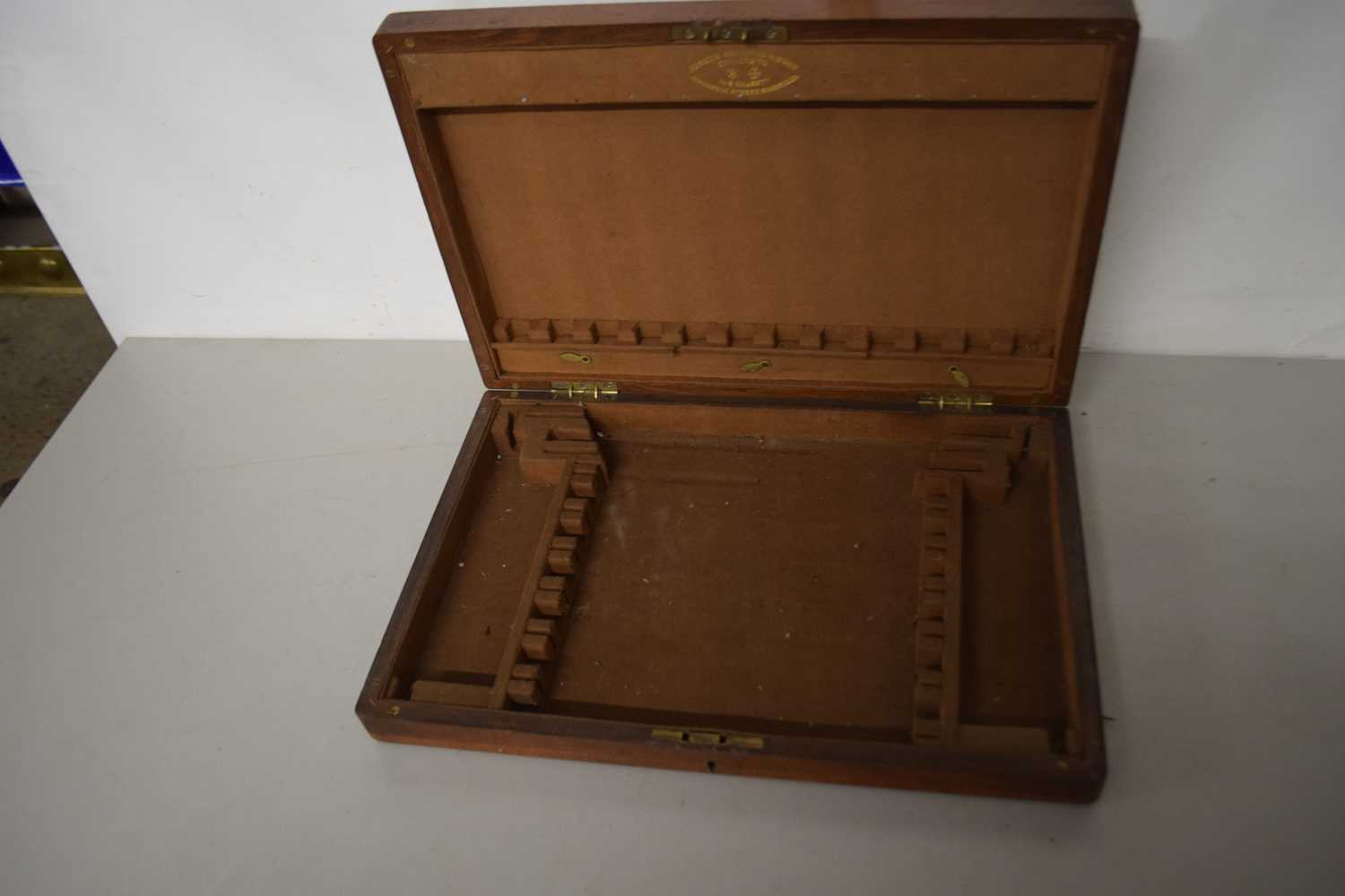 A wooden cutlery tray with brass shield, inlaid