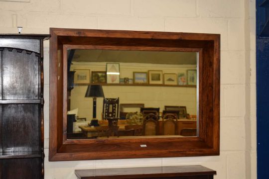 A modern hardwood framed rectangular wall mirror