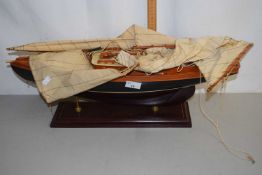 Model boat on stand with sails