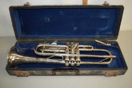 A cased trumpet marked Emo Champion
