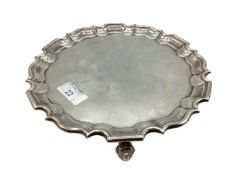 Sterling silver circular card tray raised on three shell feet by Goldsmith and Silversmith company