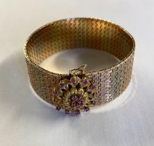 An 18ct tri-coloured gold belt bracelet with ruby set flower clasp 69.3g