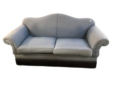 A good quality camel back two seater sofa, upholstered in a blue fabric, some minor fading and in