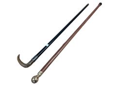 Two walking sticks, one with horn handle and silver collar, one malaca example with brass knop