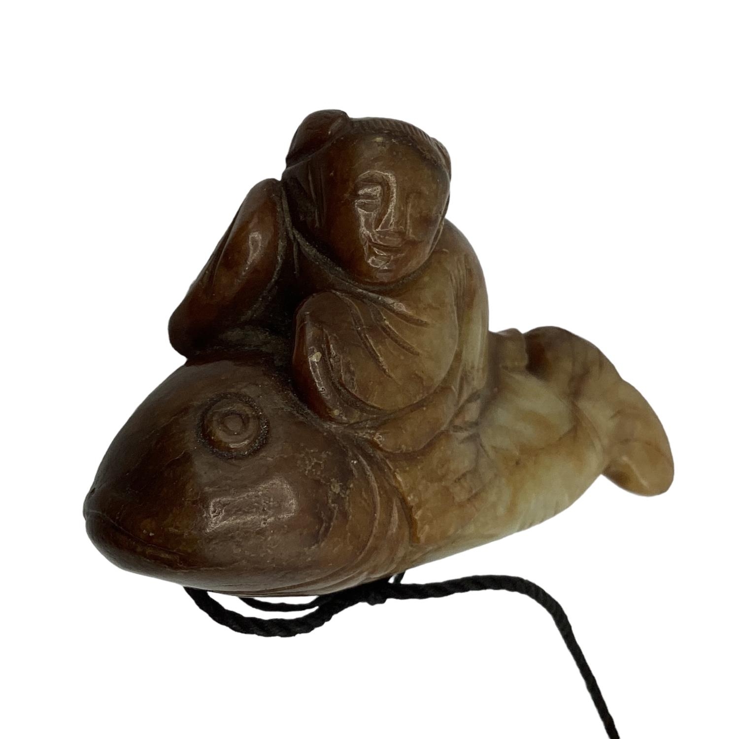 A carved jade figure of a man riding a fish 7cm x 4cm. - Image 4 of 5