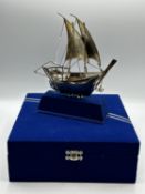 A 925 silver model of a sailing ship in presentation box. 23cm x 18cm. On stand.