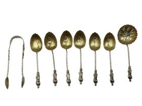 A set of sterling silver coffee spoons with apostle finials, gilt shell bowls, matching sifter and