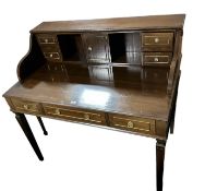 A dark mahogany desk with three drawers to front, and fitted top with 4 drawers and cubby holes,