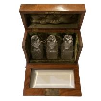 Walnut cased Tantalus, with three glass bottles