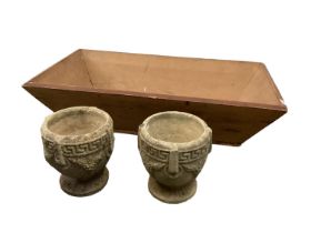 A large dough trough together with a pair of reconstituted stone urns and two wire shgellfish cages.