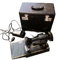 A Singer sewing machine, electric, (plug cut off), not tested, sold as seen