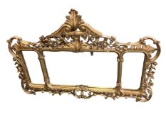 A decorative three panelled over mantle mirror, with scrolling leaf design to frame; 128cm wide
