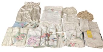 A quantity of hand needlepoint tablecloths etc