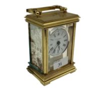 A sterling silver panelled electric carriage clock. Gilt metal case with three sterling silver