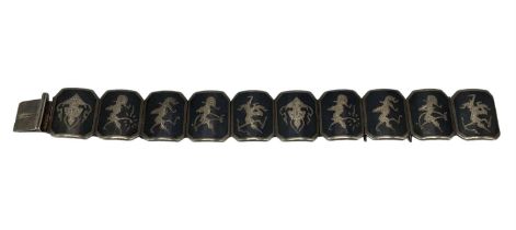 A South East Asian white metal panel bracelet marked Siam.