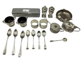 Collection of sterling silver items to include pepperettes, urn shaped salts, mustards, coin set