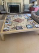 A large modern cream painted low centre table, the central glass top covering a fabric, 40H x 218W x