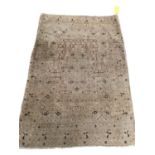 A modern cream ground rug, with all over stylized pattern, in used condition, sold as found