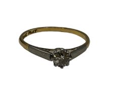 An 18ct gold and platinum single stone diamond ring. Single brilliant cut diamond in an eight claw