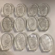 A quantity of glass paperweights, etched with animal designs, labelled " A collection of animal