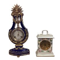 Two ceramic clocks, A Coalport example together with a Franklin Mint ceramic Lyre shaped clock. Both
