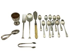 A collection of sterling silver items to include egg cup, caddy spoon, tea spoons, a spoon and
