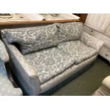A small blue and cream two seater sofa (some wear and fading to fabric)