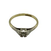 An 18ct gold and platinum single stone diamond ring. Size N. 2.00g.