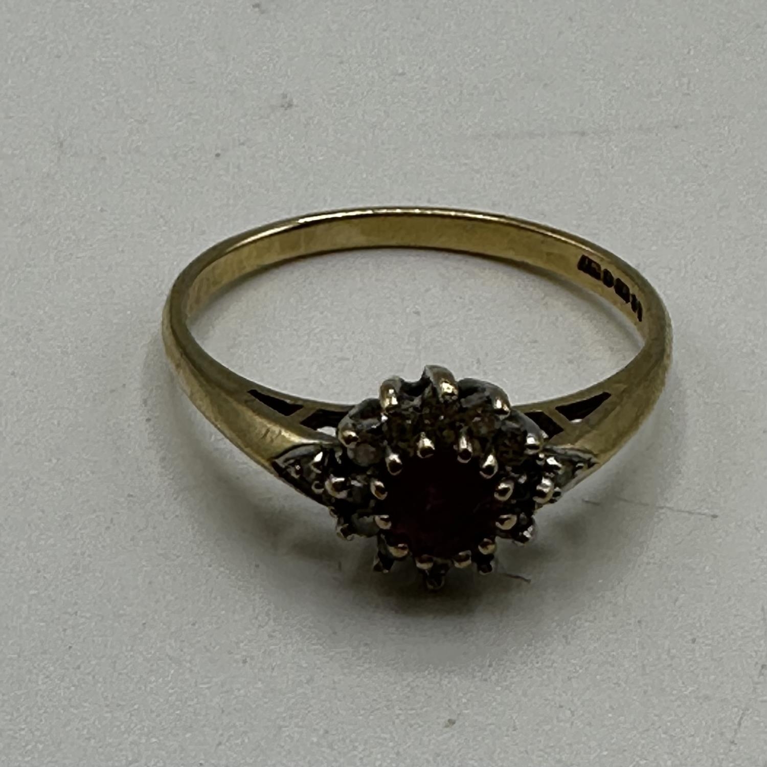 A 9ct gold ruby and diamond set flower ring. Size P. 0.80g. - Image 2 of 5