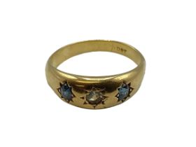 An 18ct gold sapphire and diamond hoop ring. With star set diamond and sapphire accents. Size O. 3.