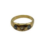 An 18ct gold sapphire and diamond hoop ring. With star set diamond and sapphire accents. Size O. 3.