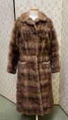 A ladies light brown fur coat, label Bradleys, condition fair, no sign of damage