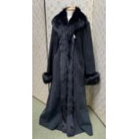 A ladies long black coat, sheepskin with trim, some very minor wear