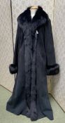 A ladies long black coat, sheepskin with trim, some very minor wear