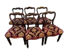 Six Victorian mahogany dining chairs, the seats upholstered in a red patterned fabric, all solid,