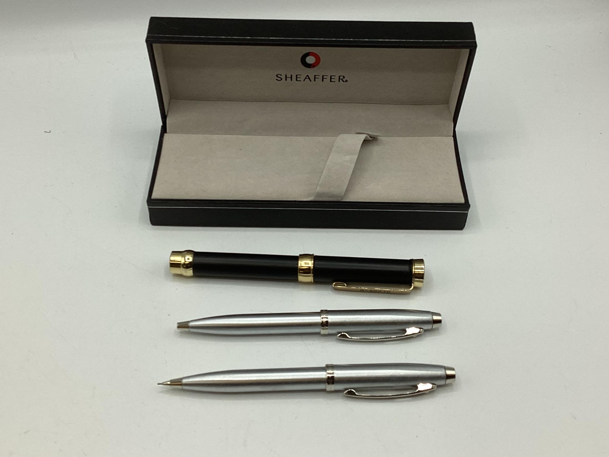 A cased pair of Sheaffer pen set and unusual pen shaped magnifying glass