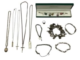 A collection of sterling silver and white metal jewellery items to include a charm bracelet, ingot