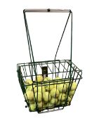 A tennis ball wire holder basket and tennis balls, all as found