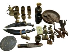 A quantity of collectables to include a kukri, brass goblets, onyx items, dogs of fo, and other