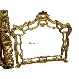 A large decorative gilt wall mirror, in the Rococo style, overall 115cm High x 123cm Wide