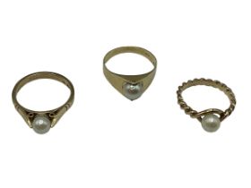 Three pearl set gold rings. Two 9ct examples and a 14ct all set with single cultured pearl. 8.3 g.