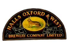 An arched shaped wooden sign, HALLS & OXFORD & WEST BREWERY COMPANY LIMITED, some general wear and