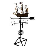 A large weather vane with a model of a ship to the top finial