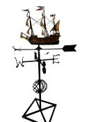 A large weather vane with a model of a ship to the top finial