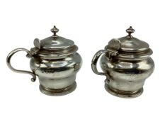 A pair of sterling silver mustards of bulbous form on circular stepped foot by D&J Welby Ltd,